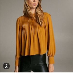 Aritzia Babaton yellow pleated blouse.